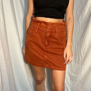Burnt orange skirt with ruching detailing on the waist.